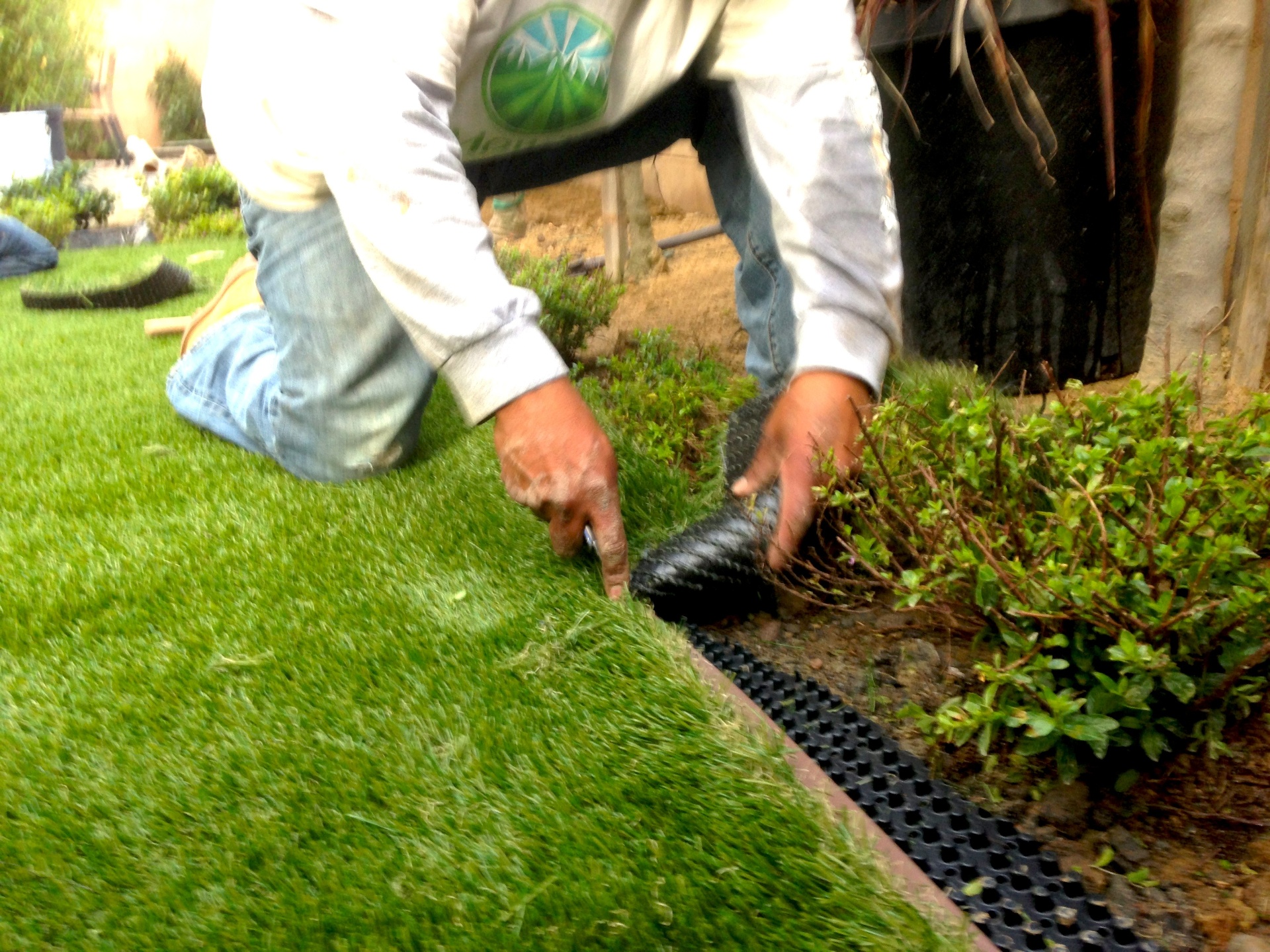 NoMow Turf installer finishing a clean turf edge