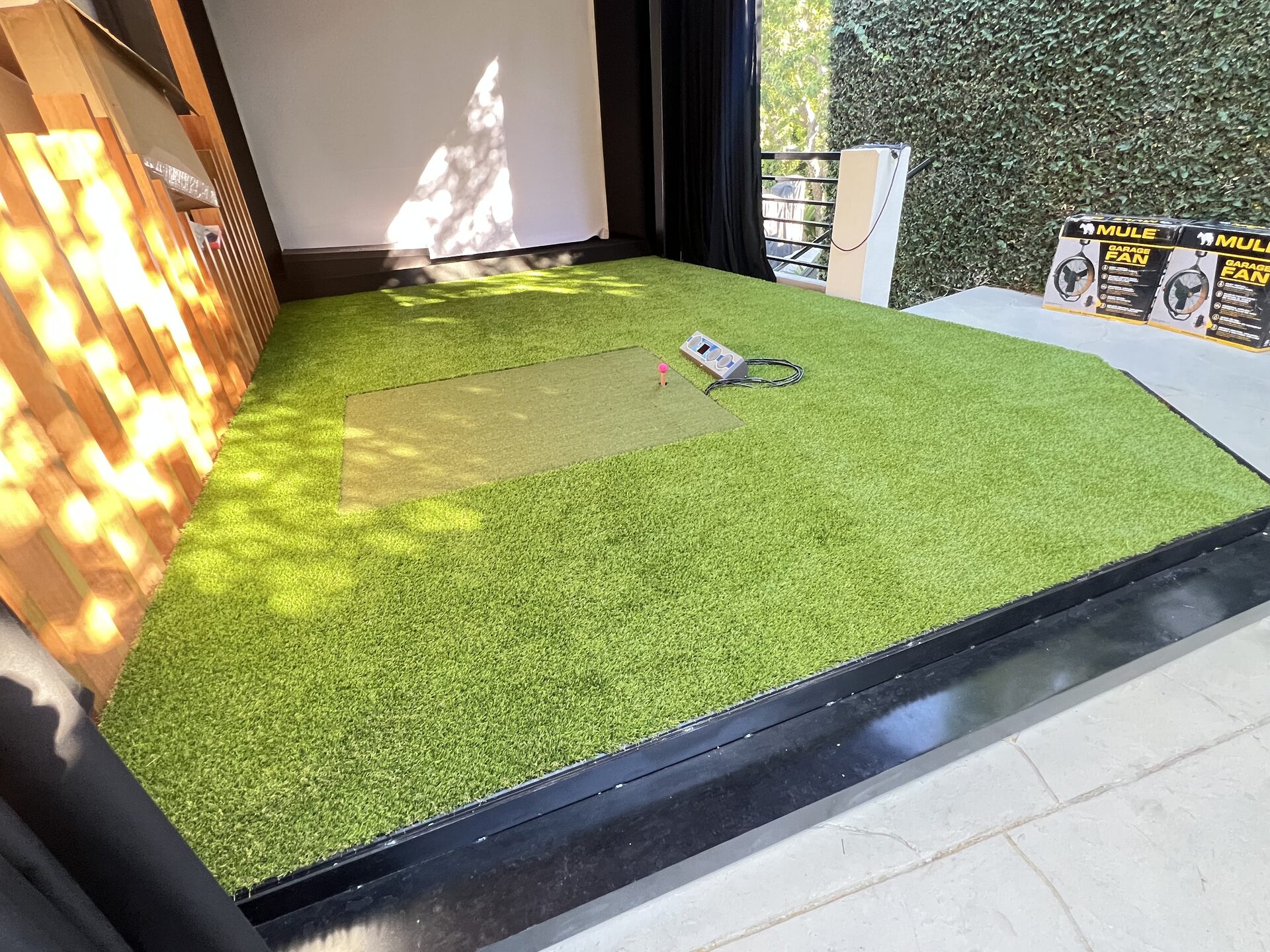 Artificial turf meeting the platform edge with a clean transition to the patio